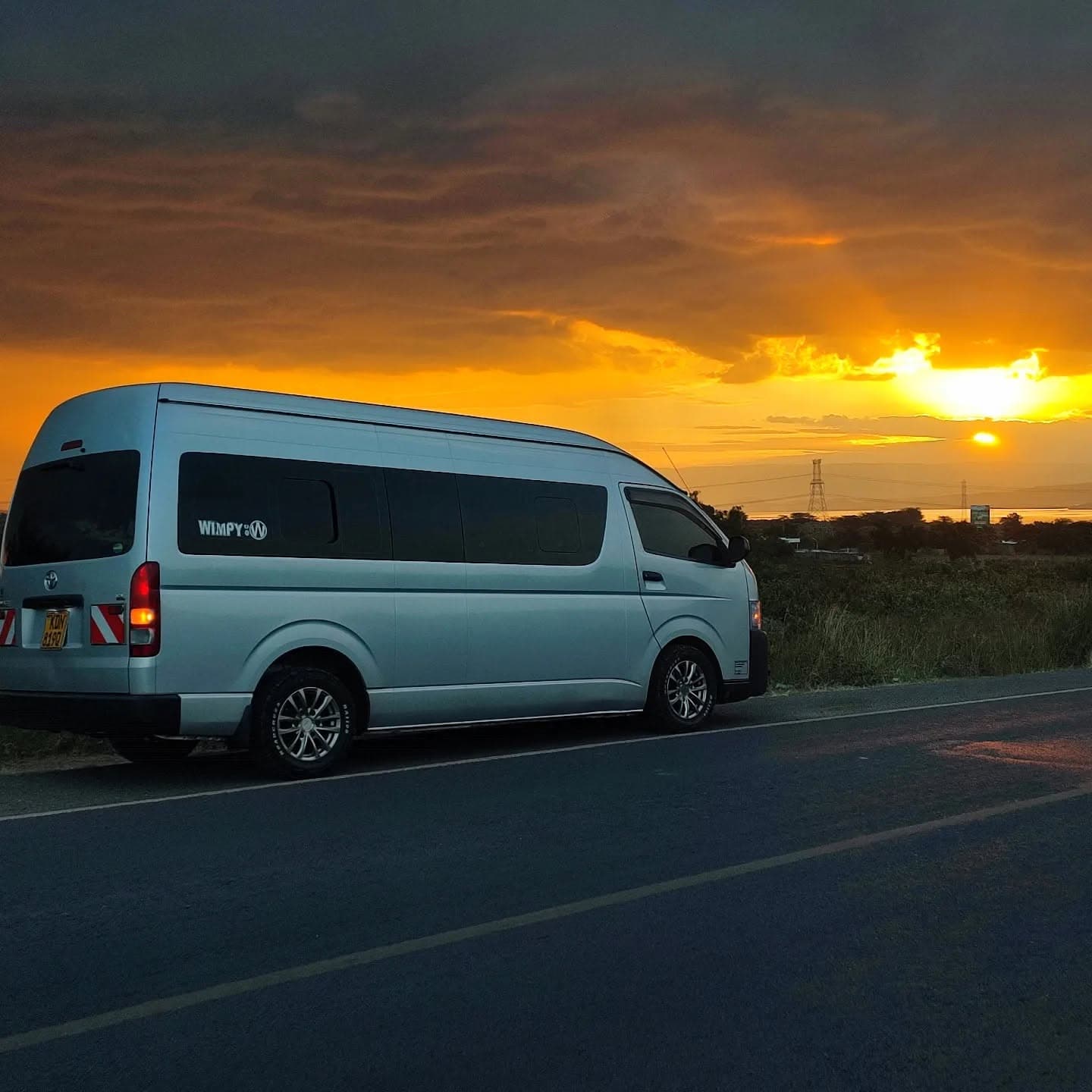 Van on the road at sunset